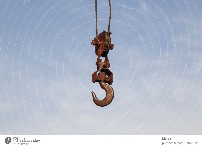 Old rusty hook of a hoisted crane in the port construction equipment industrial industry lift lifting machine old machinery metal steel heavy iron work sky