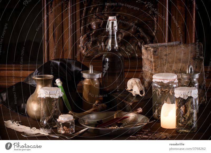 creepy witch kitchen with many disgusting ingredients for a magic potion, preserving jars and ancient utensils darkly lit with candlelight for Halloween