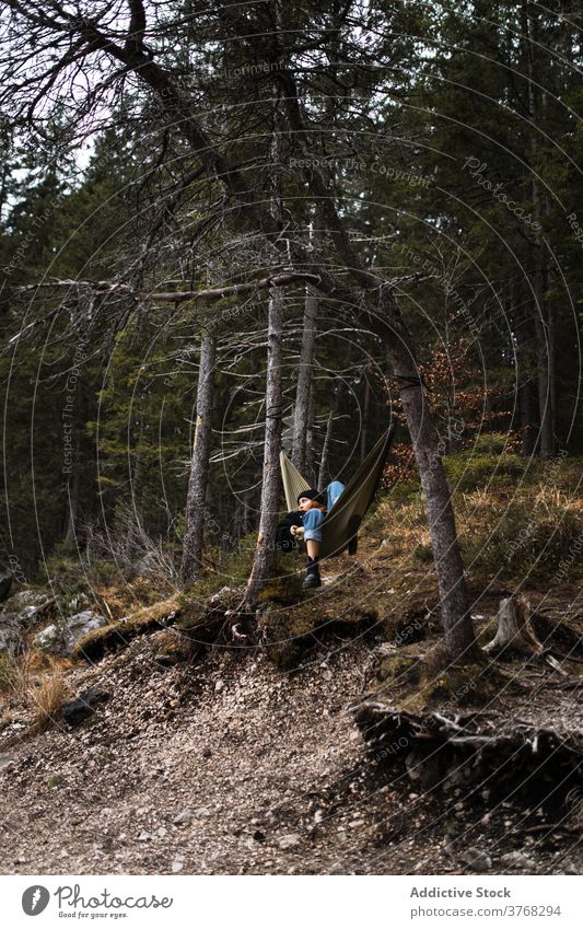 Woman relaxing in hammock near lake woman mountain admire scenery pond highland autumn female germany austria majestic nature traveler serene tourism peaceful