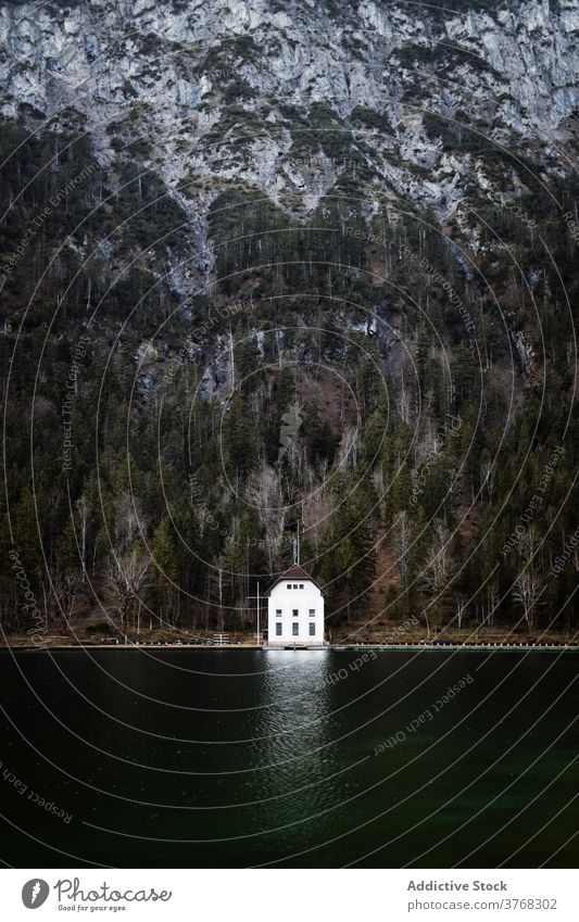 House on shore of lake in mountains house lonely cabin autumn season solitude building forest germany austria coniferous water environment rocky nature serene