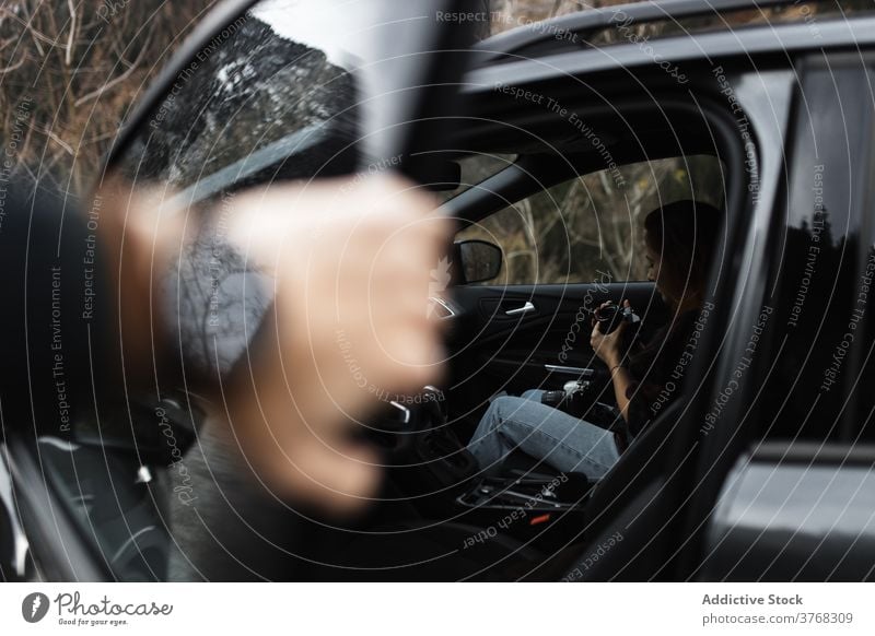 Travelling woman with photo camera sitting in car road trip traveler woodland forest autumn photography inside journey lifestyle vehicle wanderlust woods auto