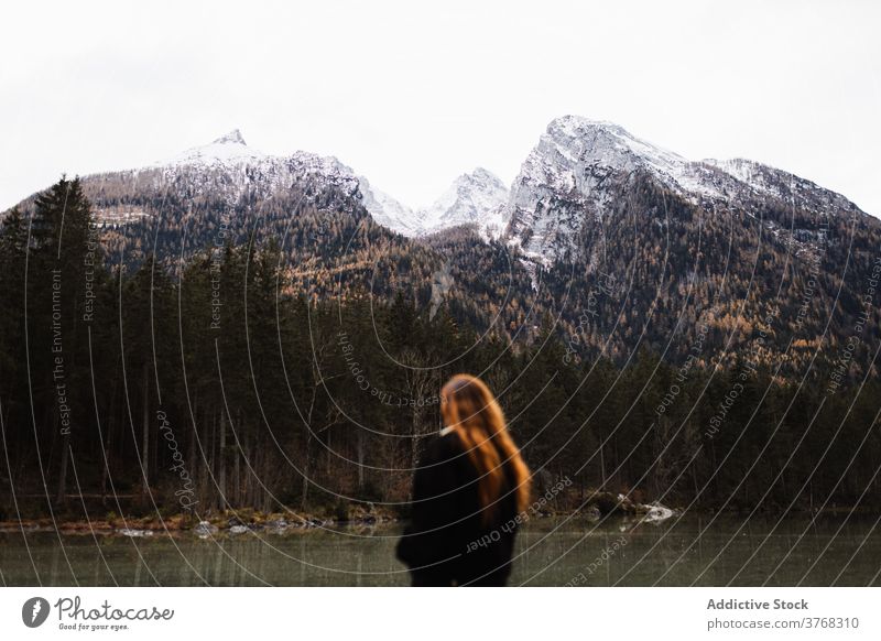 Woman standing on lake shore against mountains in autumn day woman landscape travel peak snow forest calm peaceful majestic female tourism germany austria