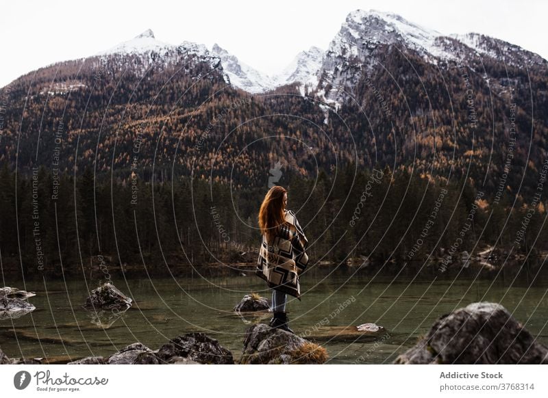 Lonely woman admiring autumn landscape of lake and mountains travel lonely rock stone peak snow traveler forest calm peaceful female tourism germany austria