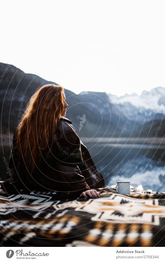 Woman relaxing near mountain lake in autumn day woman rock shore landscape travel silent peaceful recreation reflection peak snow female tourism germany austria