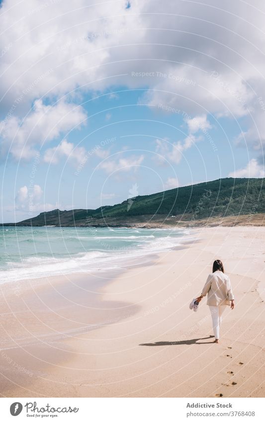 Woman walking admiring waving sea on beach woman wave sand fresh stormy alone seaside shore female travel tourism spain barefoot enjoy relax recreation breeze