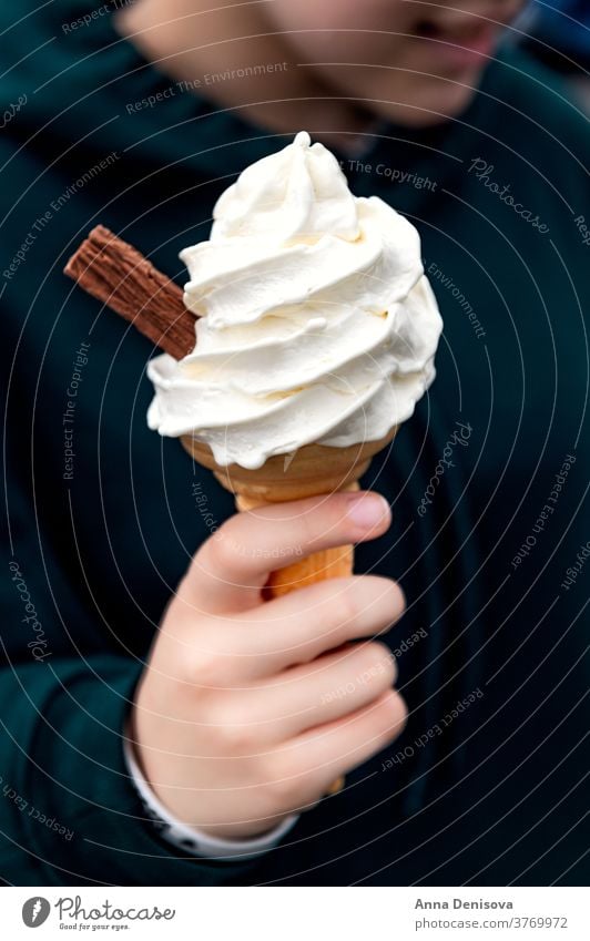 Soft vanilla ice cream with chocolate stick soft cone hand soft ice cream takeaway treat confectionery creamy cornet milk icecream tasty white sweet food