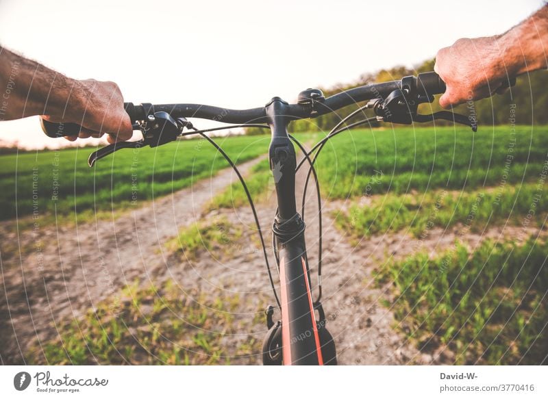 Cycling / cycling through nature Cycling tour Steering Bicycle Man salubriously Nature Movement Trip In transit especially cyclists Handlebars Lanes & trails