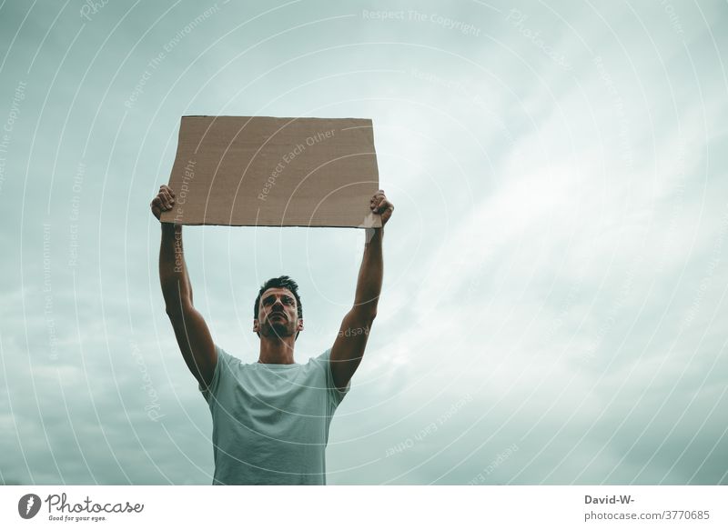 Man demonstratively holds up a sign in the air Strike Freedom of expression Fairness Society Poster Demonstration Protest Politics and state hands Uphold