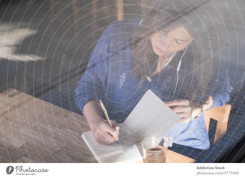 Thoughtful woman taking notes in notebook in cafe take note thoughtful morning cozy notepad planner write coffee female cup table pensive drink think beverage