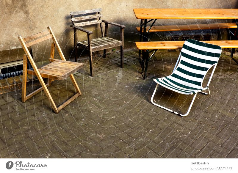 Seating area in the backyard Berlin rear building Backyard Town Scene urban Lounges Chair Folding chair Camping Camping chair Furniture beer table