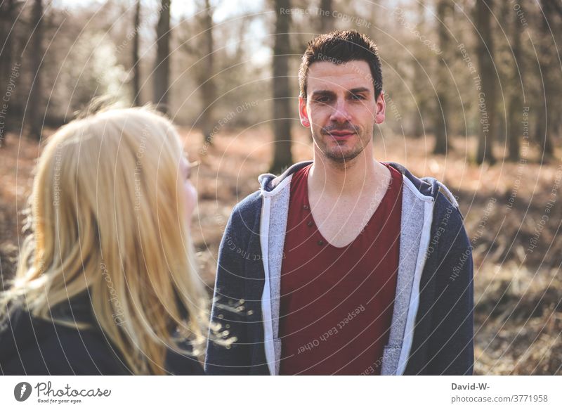 young blonde woman looks up to a man who looks into the camera look at admire laugh Looking into the camera Young woman Man Forest Autumn Communicate