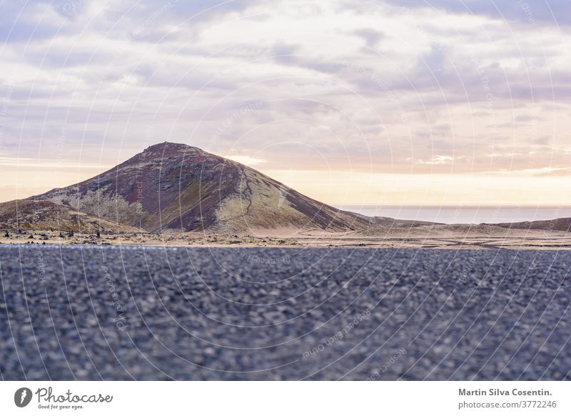 Road leads to a magnificent volcano mountain in the distance, in a dramatic scene in the Snaefellsjokull national park, Iceland. 2017 adventure autumn