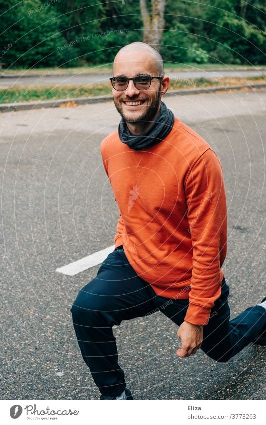 A man makes lunges (lunging) at a rest stop to get some exercise during the break of a car ride Lunges Movement Break roadhouse out now and then Street Man