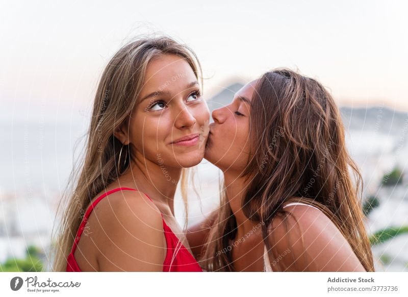 Tender lesbian couple kissing at sunset lgbt women tender hug relationship same sex love sundown summer together happy girlfriend bonding embrace romantic equal