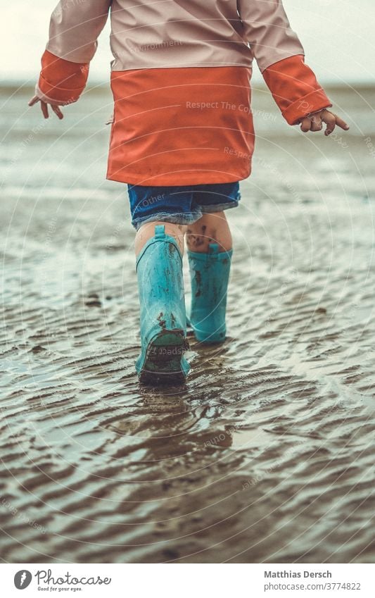 Walk in the Wadden Sea To go for a walk stroll Child children Rubber boots Mud flats watt Beach Walk on the beach Beach life Ocean North Sea North Sea coast