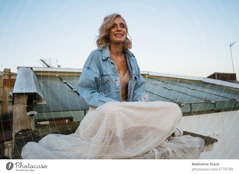 Carefree woman meditating on rooftop meditate yoga lotus pose namaste smile casual carefree asana female padmasana calm practice peaceful balance wellness lady