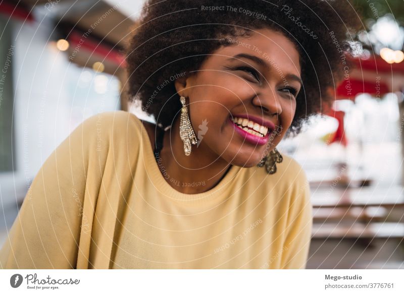 Afro american latin woman smiling. coffee shop brazilian beautiful outdoors cafe brunette curly hair time off customer confident frizzy hair leisure free time