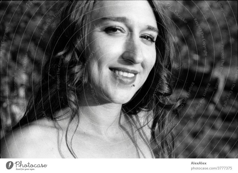 analogue, direct, close black and white portrait of a young woman with cheek dimples in front of a bush Woman already Near fit daintily Skin Naked Face