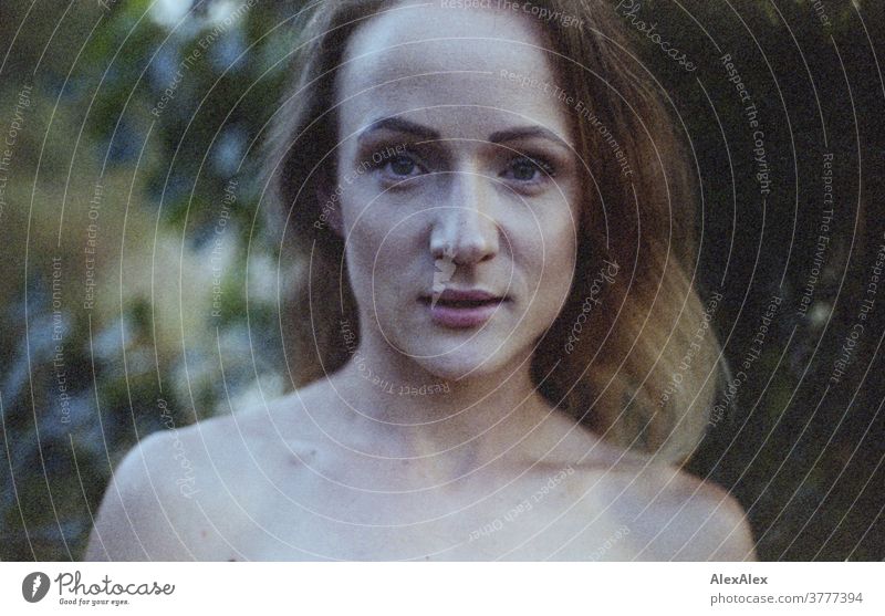 analogue, direct, close portrait of a young woman in front of a bush Woman already Near fit daintily Skin Naked Face Shoulders décolleté Blonde