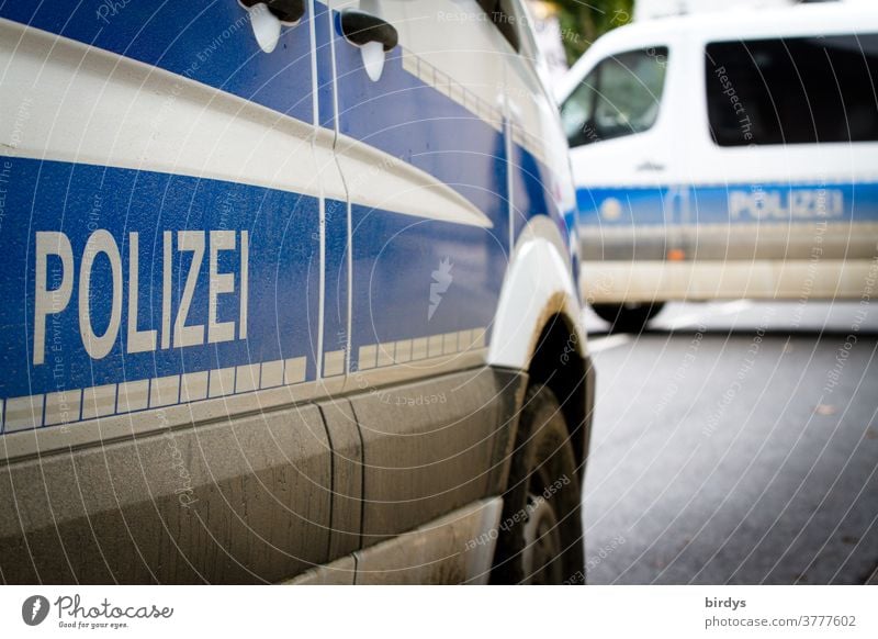 Two dirty police cars blocking a road. Police cars are blocking the road. Police Force Emergency vehicles Police vehicles police deployment Characters