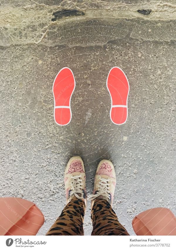 Steps on the road in red Bird's-eye view Footwear Exterior shot Day feet Legs Pants Colour photo Floor covering sneakers Red Footprint; Stand Street Brown Gray