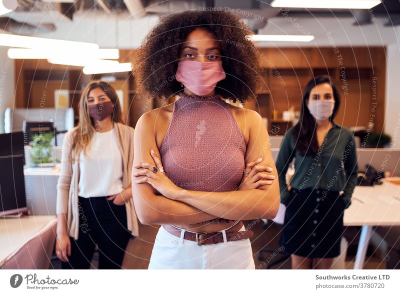 Portrait Of Female Business Team Wearing Face Masks In Open Plan Office During Covid-19 Pandemic business businesswomen team face mask face covering ppe office