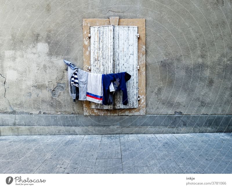 hung clothesline in front of closed window Facade Deserted Closed Laundry Colour photo out House (Residential Structure) Wall (building) Gloomy arm Shutter