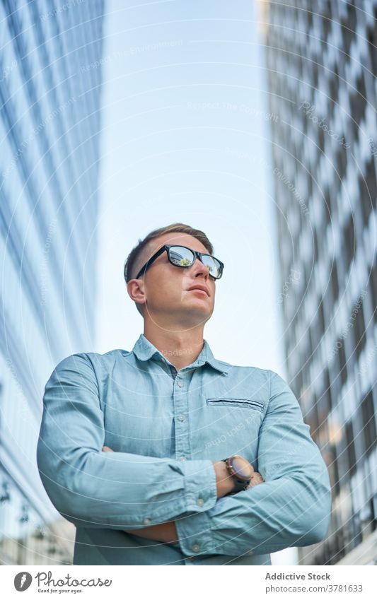 Stylish male entrepreneur standing on the street businessman downtown wait accuracy style city busy urban contemporary job confident modern manager work serious