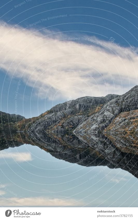 Fjord with Stone Hills and Water Reflecting Sky mountain lake cliff stone rock reflection purity nature water shore coast long shot autumn fall scenics vertical