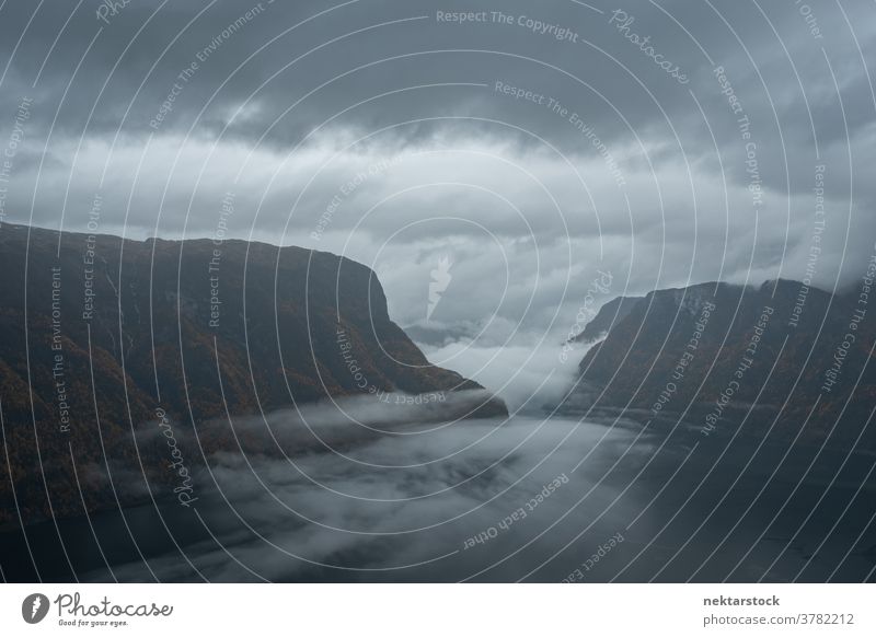 Dramatic Storm Sky Over Aurlandsfjord in Norway from Stegastein Fjord mist viewpoint height sky water cliff hill landscape mountain bad weather meteorology