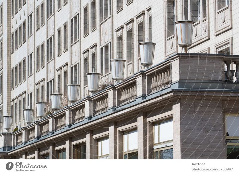 Lamp row and facade in diagonal view of a building of socialist classicism Classicism Facade row of lamps socialist urbanism Socialism Berlin Capital city