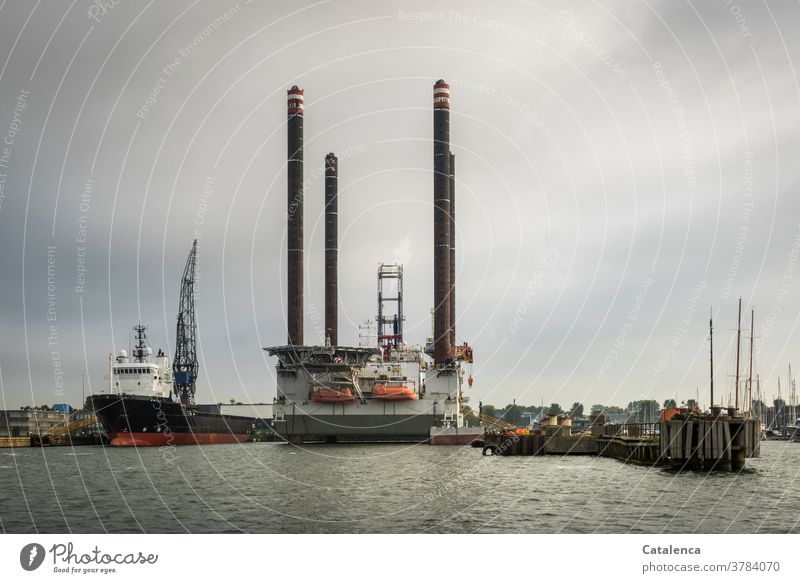 View of a floating drilling platform at the North Sea Canal near Amsterdam Crane shipping wharf Drill platform Cooking oil pier Industry technique Harbour Water