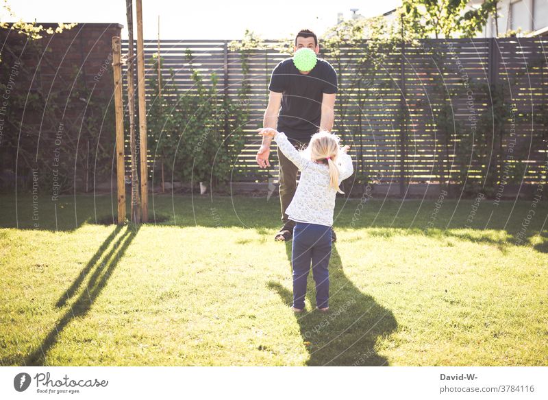 Father and child play together with the ball Child Playing Ball Garden at the same time Together Spring Summer Time Family time in common Daughter