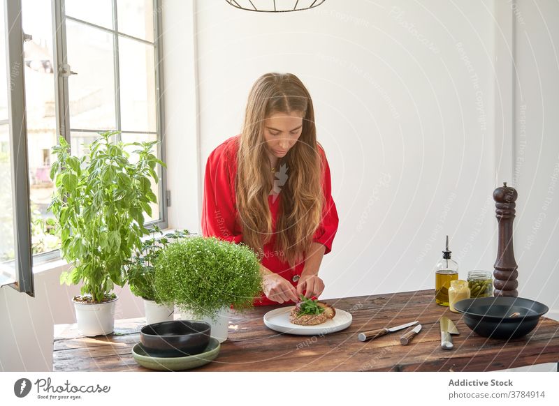 Woman garnishing Steak tartare with herbs steak tartare dish woman housewife home raw beef greenery female fresh pick meal food ingredient cuisine prepare cook