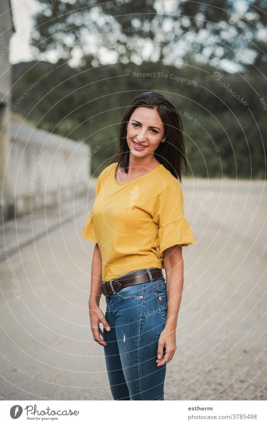 smiling young woman standing on the street beautiful elegant urban emotive gesturing natural casual expression people fashion lifestyle beauty stylish smile