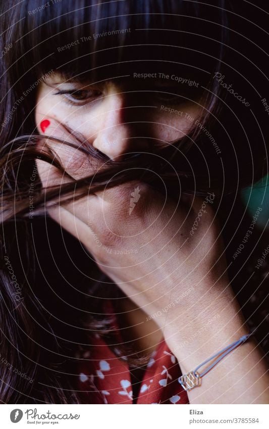 Young woman puts her hand over her mouth. Shock. Sadness. Grief Woman Fear Concern hand in front of mouth misfortune portrait Face Dramatic Downward Dark-haired