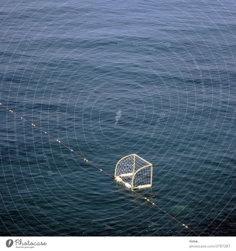 Waiting for the cue | Sinking balls Water Ocean Goal Beach ball Sports be afloat leash dividing line Playing field Deserted sunny Aquatics Waves Surface Net