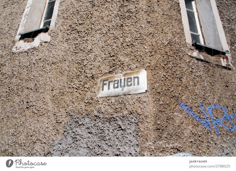 just women, a sign and two windows Facade Signs and labeling street sign Word GDR Wall (building) Window Ravages of time Weathered Typography Retro Past Plaster