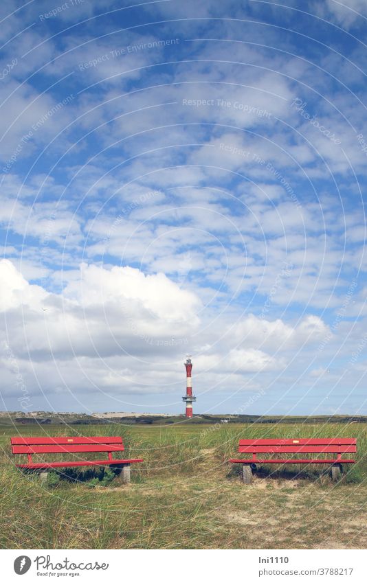 two red benches in the background blue cloudy sky with new lighthouse of Wangerooge Lighthouse North Sea Island marshland Clouds Beautiful weather dunes wide