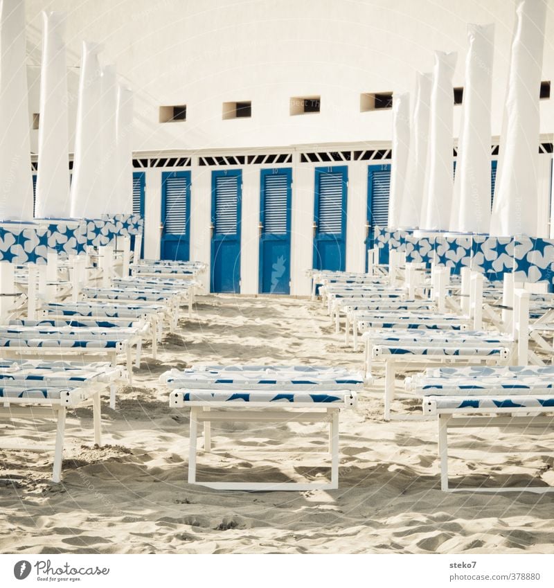 beach ghetto Tourism Summer vacation Sand Beach Clean Blue White Changing room Sunshade Deckchair Coast Subdued colour Exterior shot Deserted