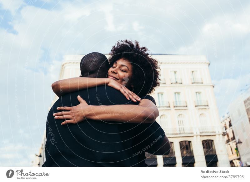 Happy african american couple hugging city love people relationship embracing happiness young happy woman two boyfriend romance together outdoors romantic