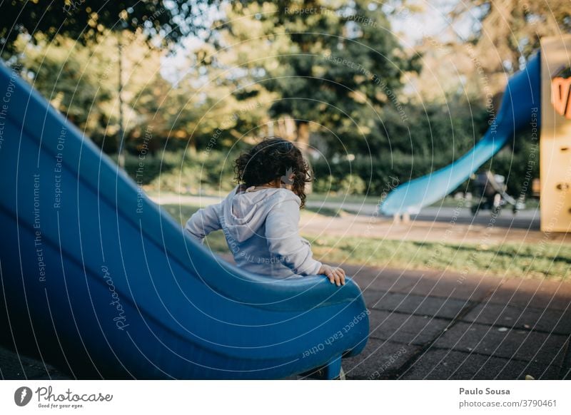 Girl playing on slide Playground Slide Kindergarten Park Colour photo Leisure and hobbies Child Day Infancy Joy Playing Exterior shot 1 - 3 years Multicoloured