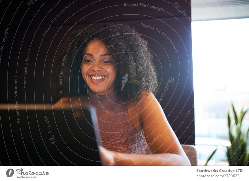 Portrait Of Businesswoman Sitting At Meeting Table Working On Laptop In Modern Open Plan Office business businesswomen meeting office sitting boardroom table