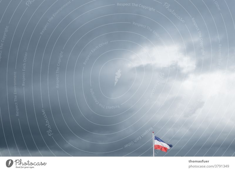 Flag of Schleswig-Holstein in the wind under dark clouds Sky Exterior shot Clouds Blow Dark clouds brave sb./sth.