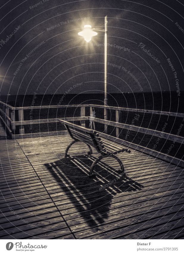 Bench on a pier Usedom Baltic Sea Ocean Island Lantern rail Park bench coast Deserted Exterior shot Black & white photo Dark Night Light Wood Shadow Sea bridge