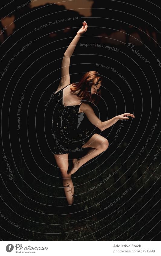 Graceful woman dancing in dark park ballet ballerina dancer meadow choreography grace flexible talent female iceland dress nature elegant balance artist classic