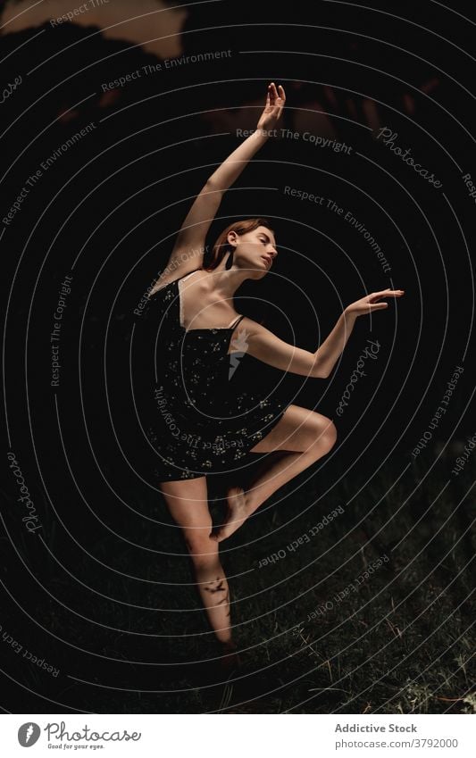 Graceful woman dancing in dark park ballet ballerina dancer meadow choreography grace flexible talent female iceland dress nature elegant balance artist classic