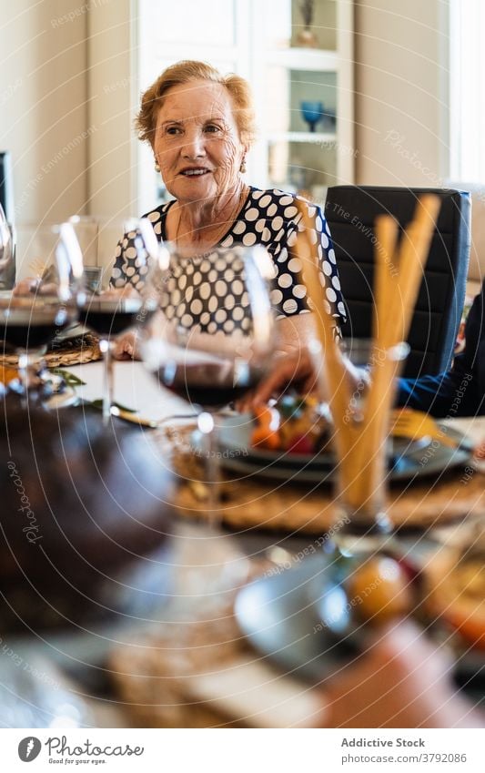 Smiling women interacting at table during Christmas dinner food alcohol friend smile celebrate christmas festive flat red wine grape cheerful event together