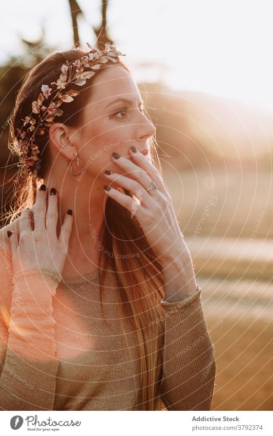 Charming woman in copper wreath touching neck gently in nature charming touch neck sensual pleasant serene gentle tender sensitive trendy gorgeous grace