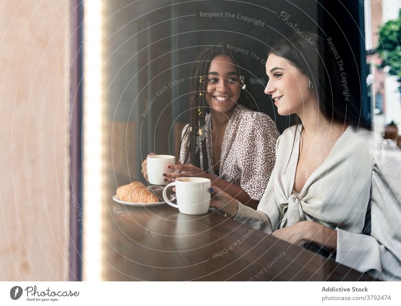 Young stylish women having coffee break in cafe friend meeting happy cheerful together chat style gather enjoy trendy young millennial drink girlfriend